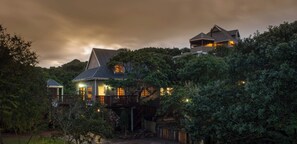 A house with multiple levels, surrounded by dense foliage, and featuring a prominent balcony. - 3040 on Freshwater (Port Alfred)