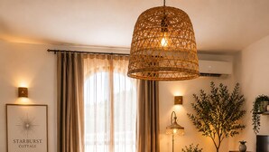 A cozy living room with a sofa, a coffee table, and a hanging light fixture. - Dragonfly Retreat Málaga | Private Villa & Rose Pool (Coín)