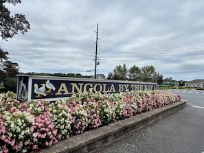 A sign with the text 'ANGOLA BY THE BAY' and a decorative sailboat. - Anchor Down by the Bay,  A Restful Retreat   in Lewes (Lewes)