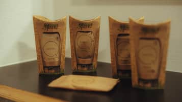 Three brown paper bags with 'Motel' printed on them, placed on a wooden surface.