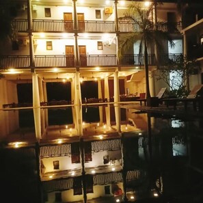 A multi-story building with balconies and a pool reflecting the structure. - Oga Reach Yala (thissamaharama)