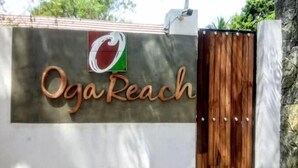 A sign with the name 'Oga Reach' and a logo above it. - Oga Reach Yala (thissamaharama)