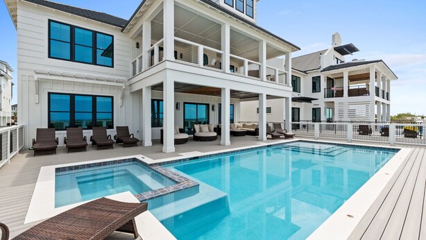 A large, multi-story house with a swimming pool, multiple balconies, and outdoor seating areas. - Saylor's Delight: Beachfront NEW BUILD, Sugar Sands Mexico Beach, Private Pool & (Mexico Beach)
