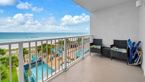 A balcony with a view of the beach and pool area. - The Summit 525 (Panama City Beach)