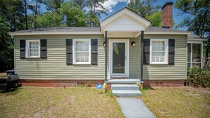 A single-story house with a front porch, a brick foundation, and a small front yard. - Welcome to the Honey House in beautiful Hampton South Carolina (Hampton)