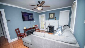 A living room with a sofa, chairs, a TV, a fireplace, and a ceiling fan. - Welcome to the Honey House in beautiful Hampton South Carolina (Hampton)