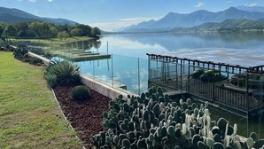 A lake with a dock, cacti, and mountains in the background. - Unique Lakefront estate, Santiago NL minutes from Monterrey, villa la Boca (Santiago)