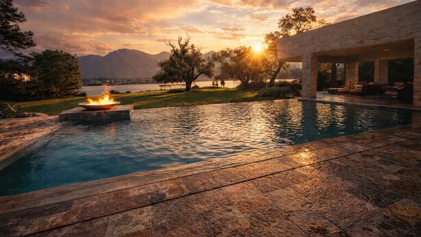 A swimming pool with a fire feature, surrounded by stone tiles, with a view of mountains and a sunset. - Unique Lakefront estate, Santiago NL minutes from Monterrey, villa la Boca (Santiago)