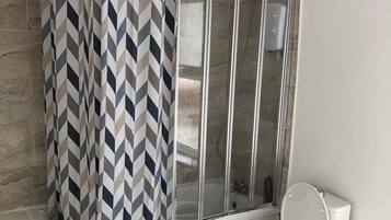 Separate bathtub and shower, deep-soaking bathtub, hair dryer, towels
