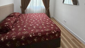 A bedroom with a bed, a ceiling fan, an air conditioning unit, a window with curtains, and a wall-mounted mirror. - Sufi Homestay for Muslim only (Nilai)