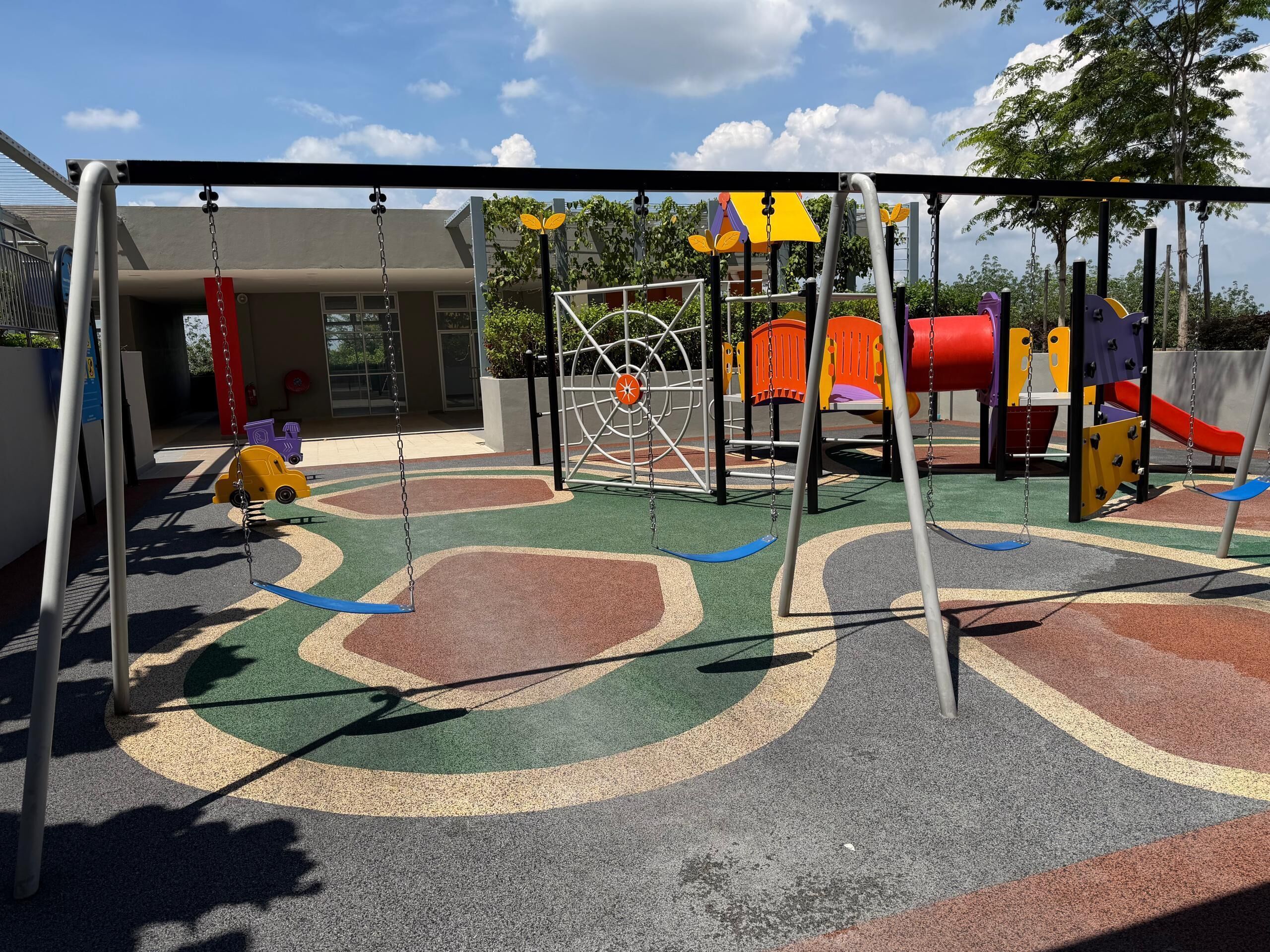 A playground with swings, slides, and climbing structures.