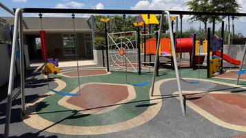 A playground with swings, slides, and climbing structures.