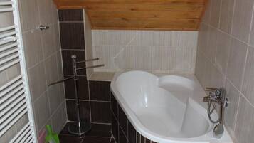 A bathroom with a bathtub, a shower, and a toilet.