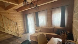 Un interno in legno con un tavolo da pranzo, sedie e un divano.