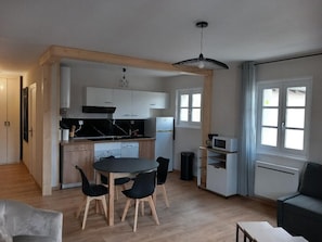 A compact living space with a kitchen, dining area, and seating area.