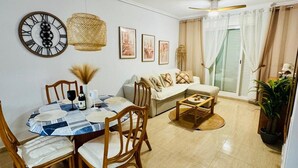 A dining area with a round table, chairs, and a ceiling fan.