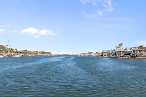 A waterfront view with docks, boats, and buildings.