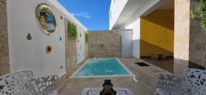 A pool area with a white wall, a door, and a bench. - Sunflower Villa Punta Cana (Punta Cana)
