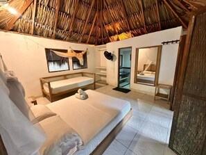 A room with a bed, a bench, a mirror, and a door leading to a balcony. - Orika del Mar  (Rosario Islands)