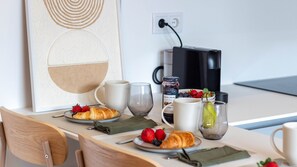 A breakfast table with croissants, strawberries, blueberries, a jar of jam, a glass of water, and a cup. - ASTRO Emanuelle E by LovelyStay (Leça da Palmeira)