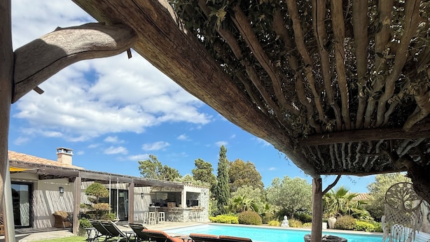 A poolside area with a pergola, lounge chairs, and a view of a house and pool. - Casa Avvena 2 - Bed and breakfast with breakfast (Lecci)