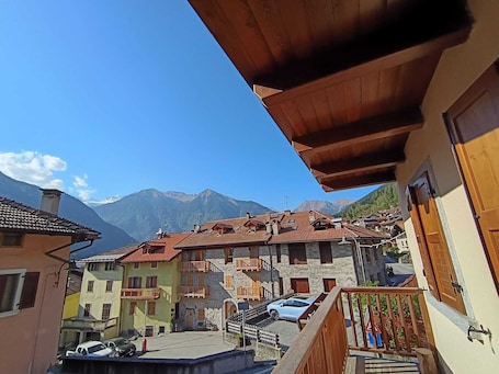 A traditional European village with stone buildings, balconies, and a mountain backdrop.. Apartment Brenta - Dolomiti Alpine Homes
