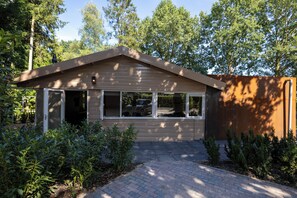 A single-story house with a gabled roof, a front porch, and a driveway leading to the entrance.