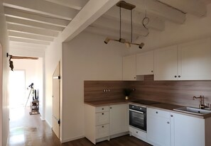 A modern kitchen with white cabinets, a wooden countertop, and a built-in oven. - Holiday Home 'Mendi Borda' with Private Terrace, Wi-Fi and Air Conditioning (Larribar-Sorhapuru)