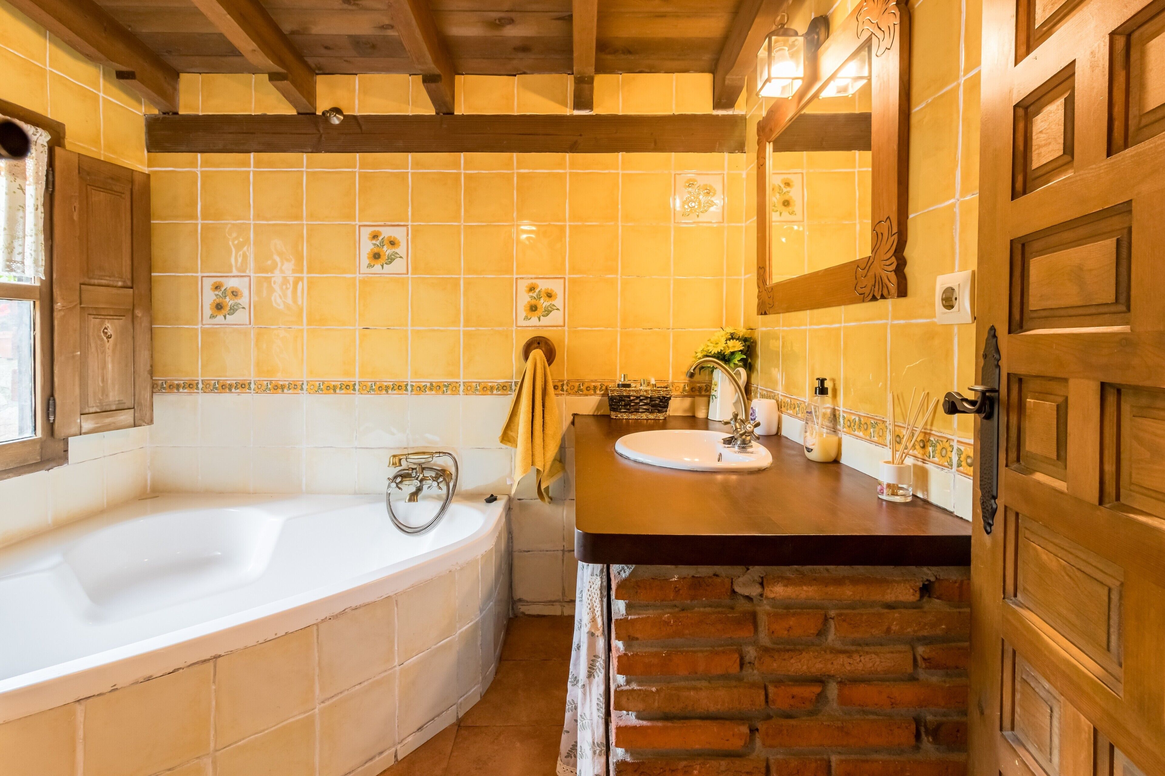 A bathroom with a bathtub, a sink, and a mirror.