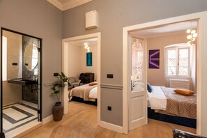 A modern bedroom with a bed, bedside table, and a nightstand.
