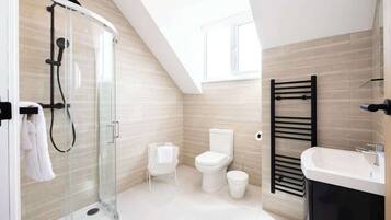 Shower, hair dryer, towels, shampoo