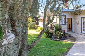 A tree with various ceramic items hanging from its branches. - Coastal Retreat close to Devonport Beaches (Auckland)