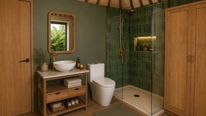 Une salle de bain avec un meuble-lavabo en bois, un lavabo blanc, des toilettes et une douche à parois de verre.