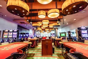 A casino with multiple gaming tables and slot machines. - Private Island Villa w/ 130’ Dock | Bimini 609 (Bimini Islands)
