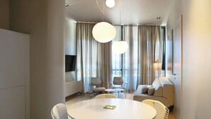 A modern dining area with a round table, chairs, and pendant lighting. - Trogir sky view suites (Trogir)