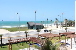 A coastal hotel with a beach view, a small building, and outdoor seating areas. - VG Fun Residence - Praia do Futuro (Fortaleza)
