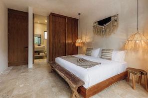 A bedroom with a wooden bed, a bench, a hanging light, and a wardrobe. - Tulumaya Boho Luxe Villa in Aldea Zama Concierge (Tulum)