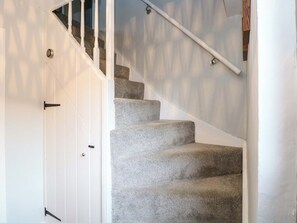 A staircase with carpeted steps and white walls. - The Mallows (Walsingham)
