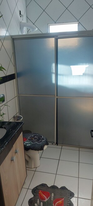 Eine Küche mit Kühlschrank, Spüle und Fenster.