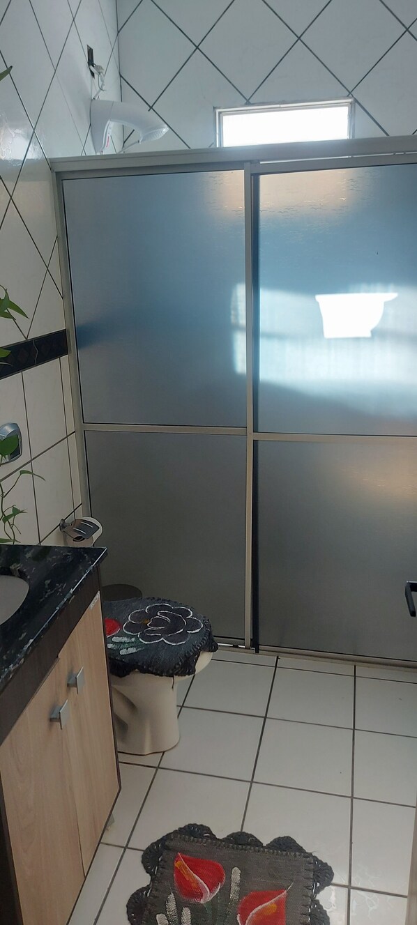 Eine Küche mit Kühlschrank, Spüle und Fenster.