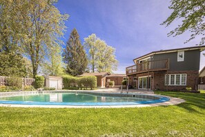 A residential area with a swimming pool, a two-story house, and a small shed. - Cottage Style living within city limit! (London)