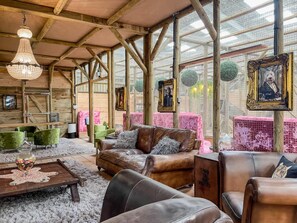 A rustic interior with wooden beams, leather sofas, and a large window with a view. - Berney Lodge - Puppy Lounge Arcades Games Room (Market Rasen)