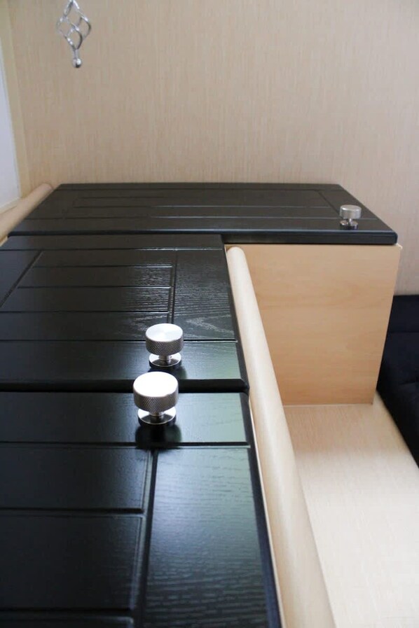 A bed with a black headboard and a wooden sideboard. - Sheepy Lodge - Puppy Lounge Arcades Games Room (Market Rasen)