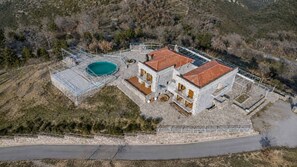 A large house with a swimming pool, multiple balconies, and a stone facade. - Faris Hotel - Cozy Triple Room Near Sparta (Sparta)
