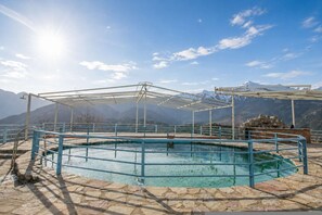 A pool with a metal frame and a stone border, surrounded by a metal railing. - Faris Hotel - Cozy Triple Room Near Sparta (Sparta)