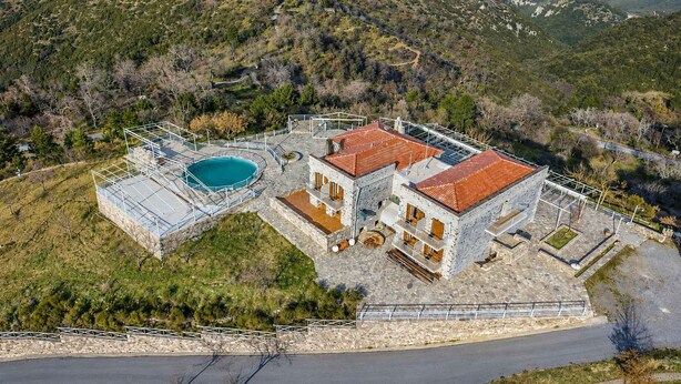 A two-story stone building with a swimming pool, surrounded by a stone wall and a metal fence. - Faris Hotel Taygetos Comfy Suite Near Sparta (Sparta)