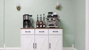 A kitchen with a white cabinet, a coffee maker, and condiment bottles. - Country Oasis 4-bedroom farmhouse in tranquil Shelby with cozy charm (Shelby)