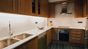 A modern kitchen with wooden cabinets, a stainless steel sink, and a dishwasher. - Cozy House near Aigüestortes Park, 6 ppl, Pets welcome (Espot)