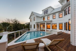 A two-story house with a swimming pool, wooden deck, and outdoor seating. - The Ivory Tide by Charleston Vacays (Isle of Palms)