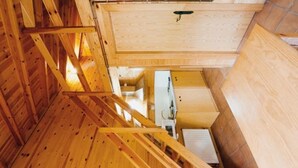 A wooden interior with a staircase, a white cabinet, and a wooden wall. - Wooden Bungalows near Sort - Pets Welcome (Montardit de Dalt)